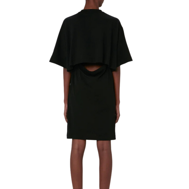 Modeled back view of a cotton Open Back T-shirt Dress, pictured against a white background from neck to ankle. The back of the dress is shown, highlighting its open back design.