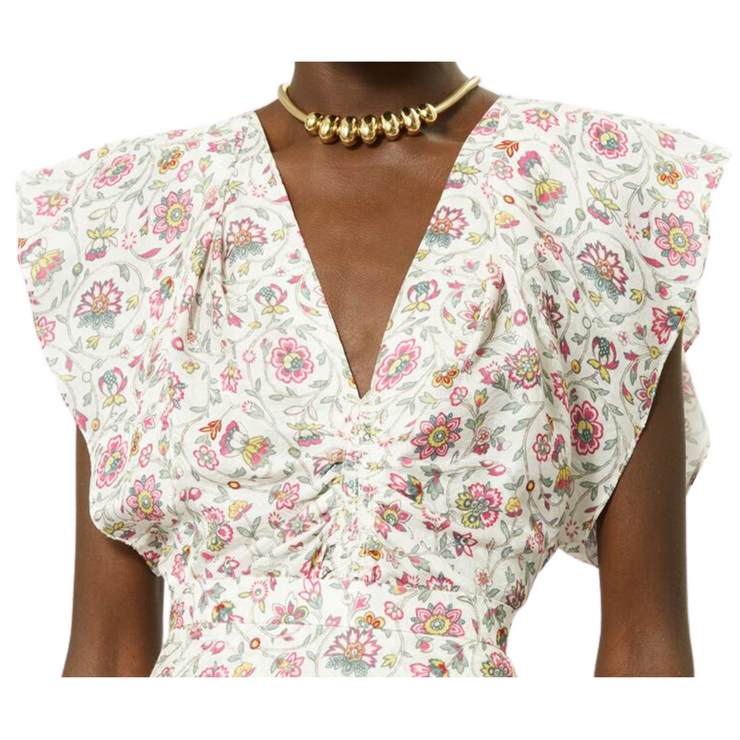 Modeled front view of a sleeveless ecru pattern top. The top is ruched through the waist with a band and is styled with a chunky gold necklace. The image is shown from chin to hip against a white background.