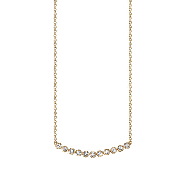 Diamond bezel necklace on white background.